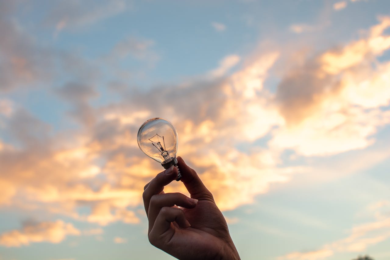 Sustainability, innovation, sustainable business, hand holding a bulb